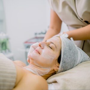 Woman receiving a facial treatment at spa.