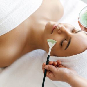 Woman receiving a relaxing facial treatment.