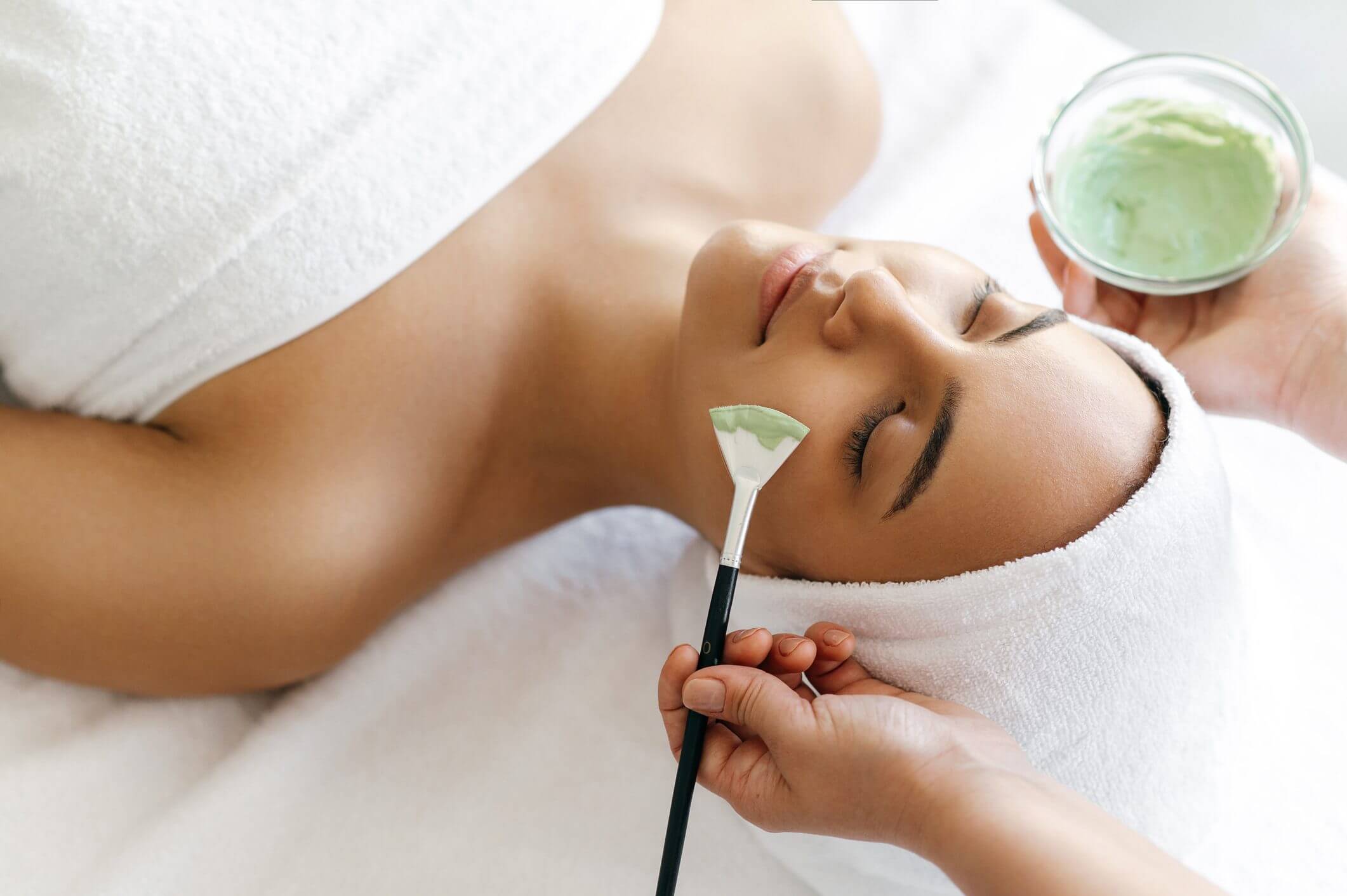 Woman receiving a relaxing facial treatment.