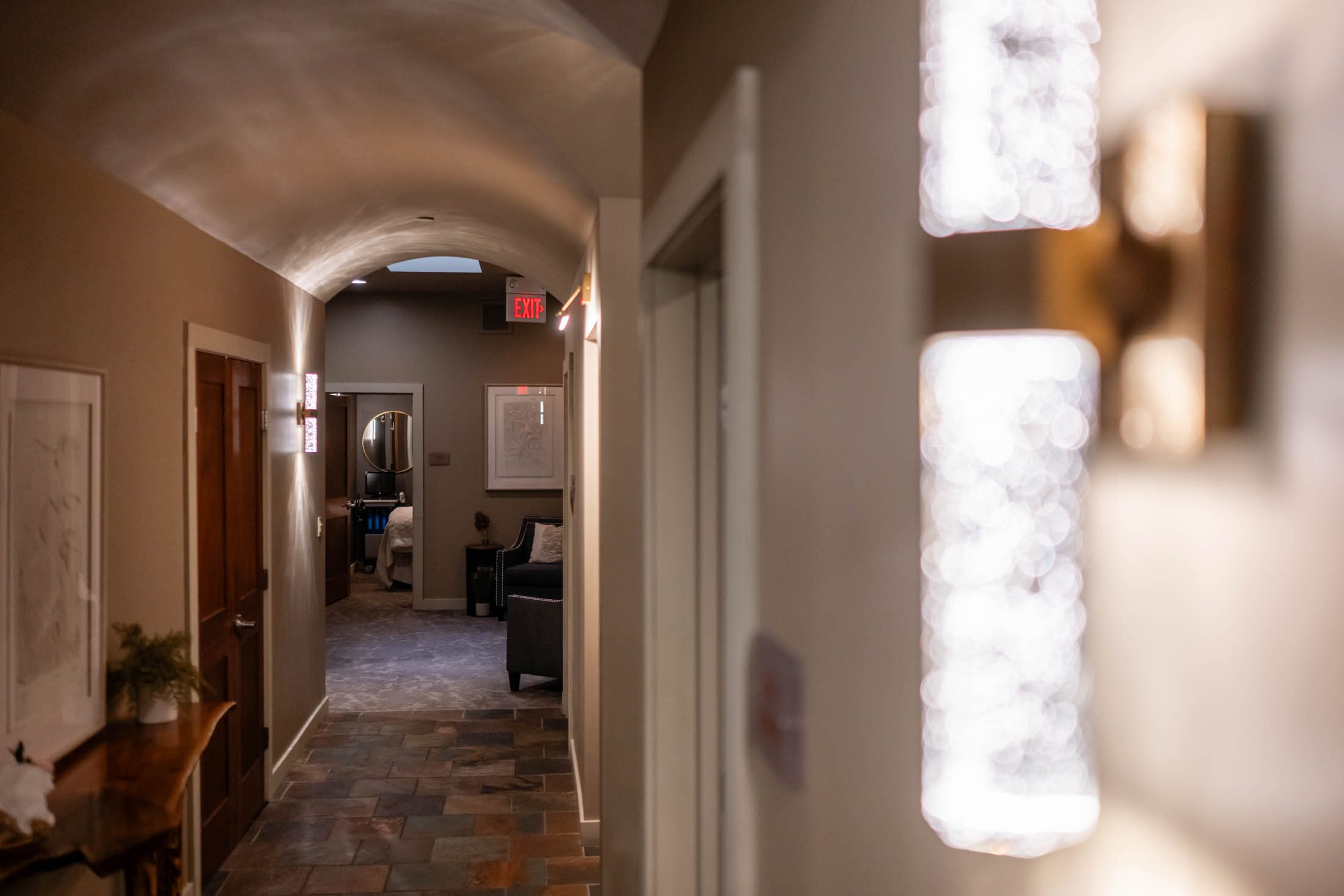 Dimly lit hallway with glowing wall lights.