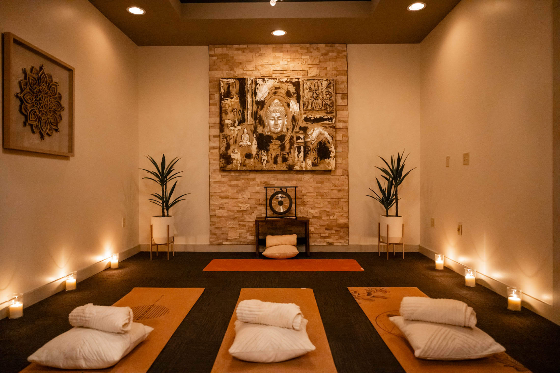 Yoga studio with mats, cushions, and candles.