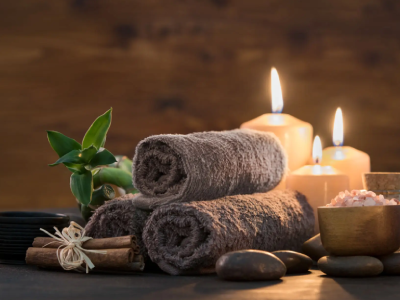 Spa setting with candles and towels.