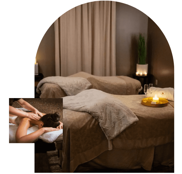 A serene treatment room set up for professional massage services featuring plush tables and candles.