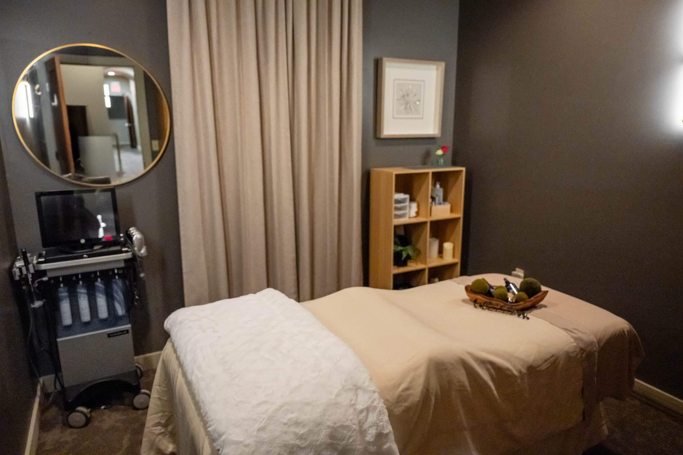 Massage room with bed and decor.