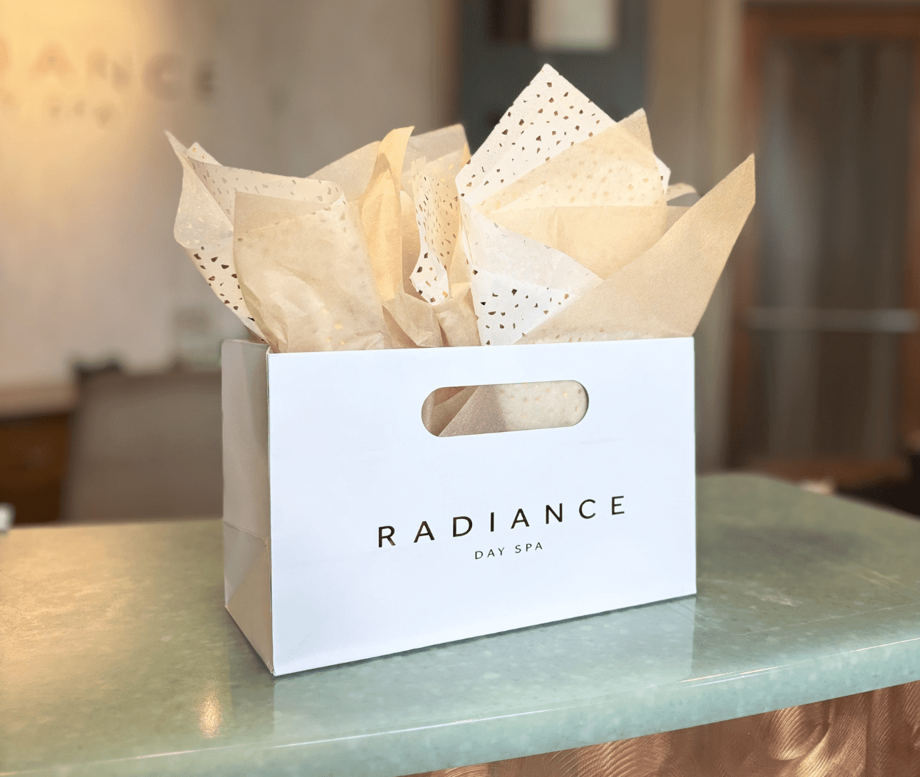 Gift bag with tissue paper on counter.